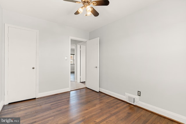 unfurnished bedroom featuring visible vents, baseboards, ceiling fan, and wood finished floors
