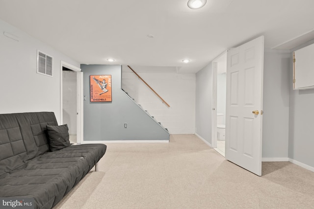 living room with recessed lighting, visible vents, and light carpet
