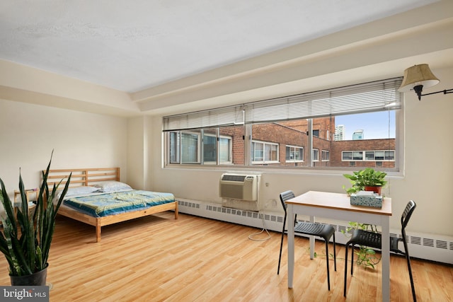 bedroom featuring an AC wall unit and wood finished floors