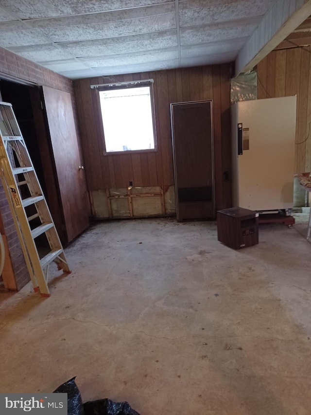interior space with wood walls and concrete floors