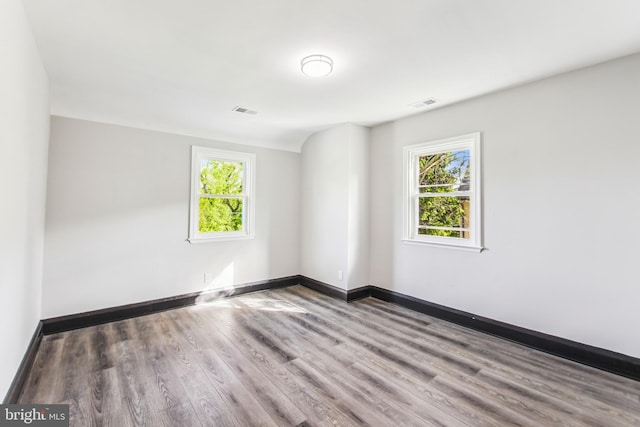 4812 Coleherne Rd, Baltimore, MD 21229 - spare room with visible vents, a healthy amount of sunlight, and wood finished floors