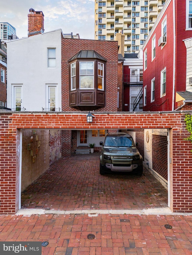 view of front of house with brick siding and cooling unit