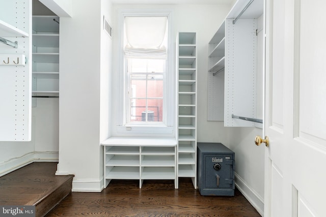 walk in closet with visible vents and dark wood-style flooring