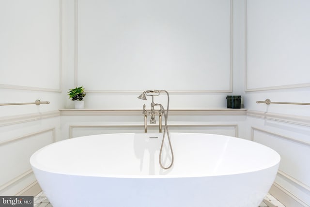 bathroom featuring a sink and a freestanding tub