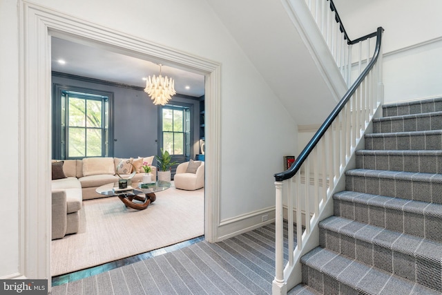 staircase with a notable chandelier, carpet, recessed lighting, baseboards, and ornamental molding