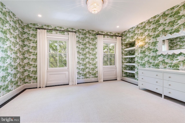 interior space with carpet floors, an inviting chandelier, baseboards, wallpapered walls, and recessed lighting