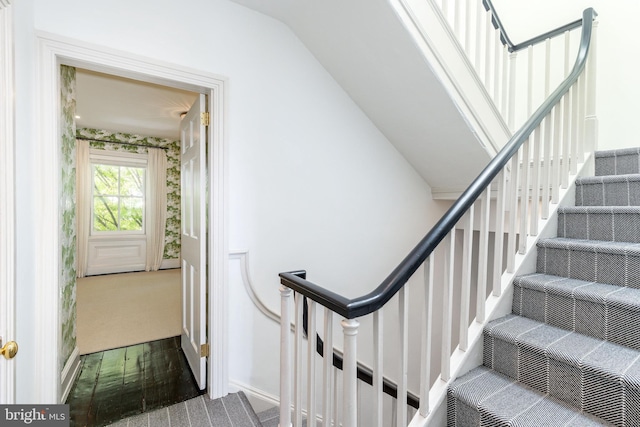 stairway featuring lofted ceiling