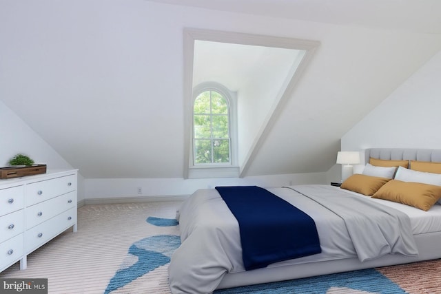 carpeted bedroom featuring vaulted ceiling