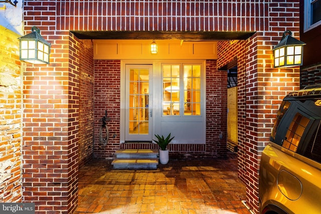 entrance to property featuring washer / dryer and brick siding