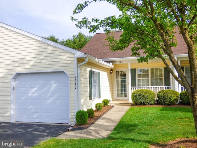 view of front of house with a shingled roof, an attached garage, a front lawn, aphalt driveway, and covered porch
