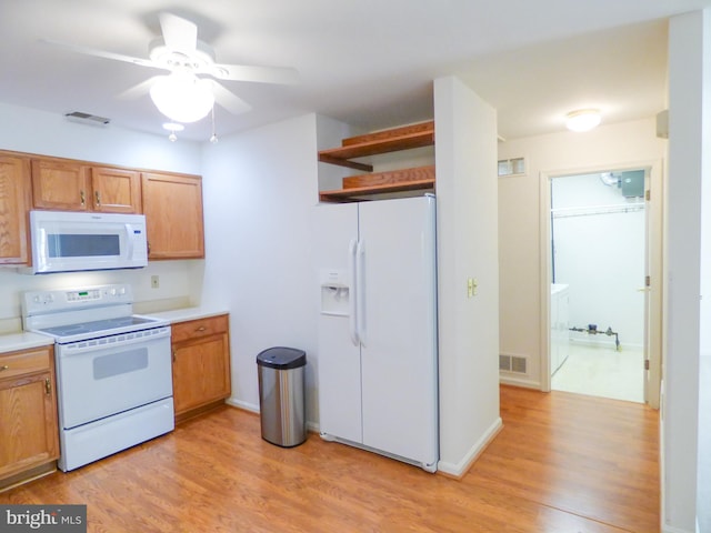 kitchen with open shelves, ceiling fan, light wood finished floors, white appliances, and visible vents