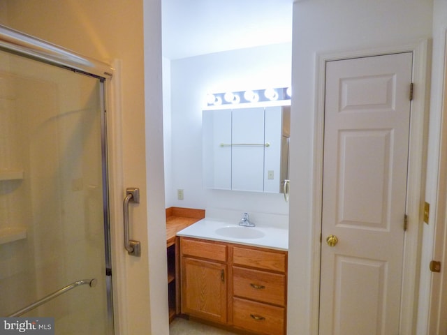 full bath with vanity and a shower stall