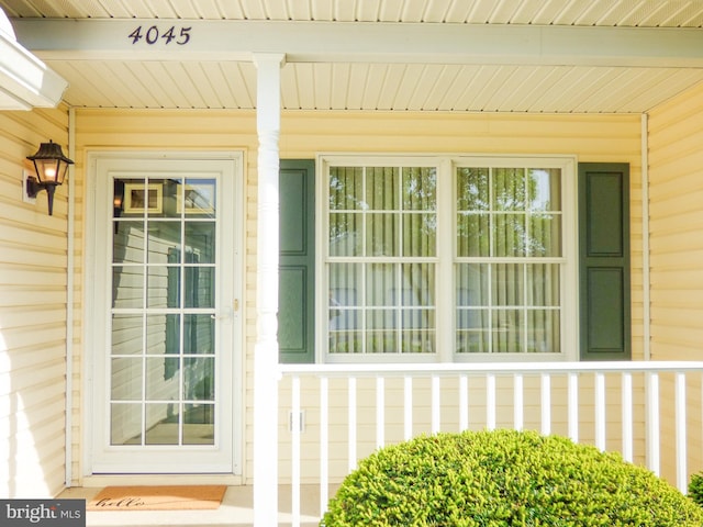 view of exterior entry featuring a porch