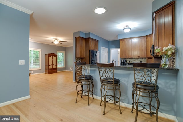 12868 Paddle Wheel Ct, Manassas, VA 20112 - kitchen with appliances with stainless steel finishes, ornamental molding, a peninsula, backsplash, and baseboards