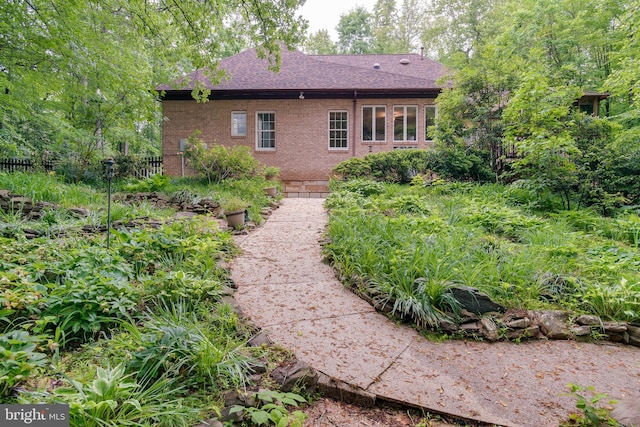 12868 Paddle Wheel Ct, Manassas, VA 20112 - rear view of house with brick siding, a shingled roof, and fence