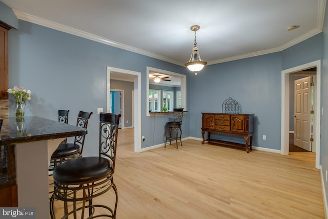 12868 Paddle Wheel Ct, Manassas, VA 20112 - dining space with light wood finished floors, ornamental molding, baseboards, and ceiling fan