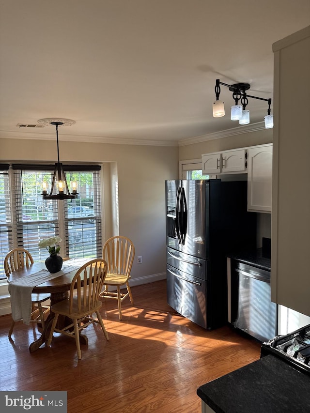 8549 Stonewall Rd, Manassas, VA 20110 - dining room with wood finished floors, ornamental molding, baseboards, visible vents, and a notable chandelier