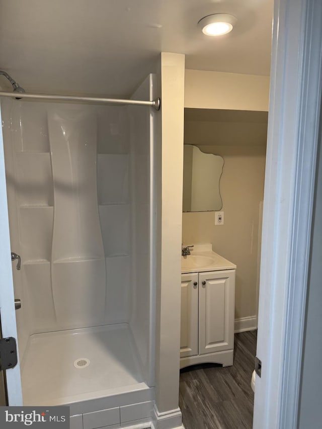 8549 Stonewall Rd, Manassas, VA 20110 - bathroom featuring a stall shower, vanity, baseboards, and wood finished floors