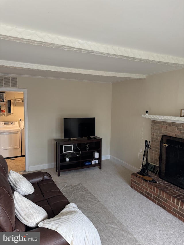 8549 Stonewall Rd, Manassas, VA 20110 - living area featuring carpet, a fireplace, washer and clothes dryer, visible vents, and baseboards
