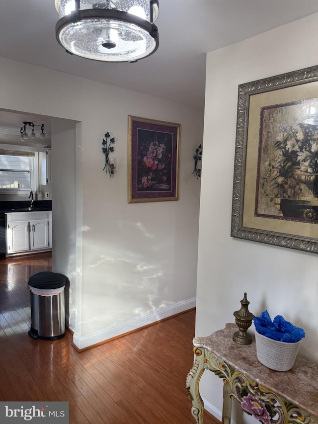 8549 Stonewall Rd, Manassas, VA 20110 - hallway with dark wood-style flooring, baseboards, and a sink
