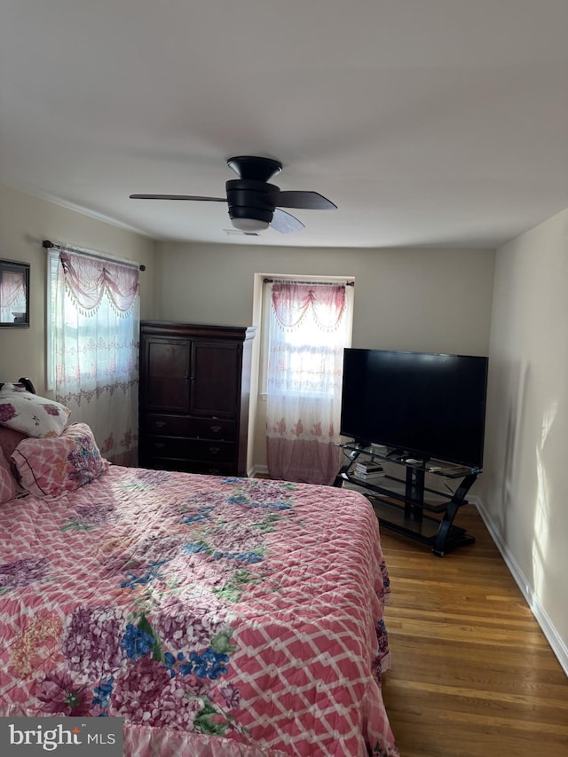8549 Stonewall Rd, Manassas, VA 20110 - bedroom with ceiling fan, wood finished floors, and multiple windows