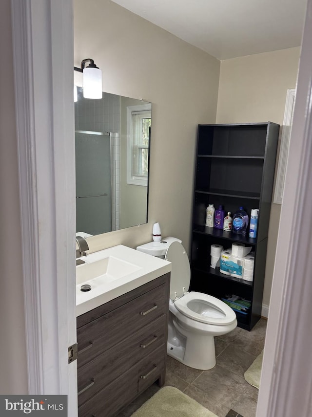 8549 Stonewall Rd, Manassas, VA 20110 - bathroom featuring toilet, walk in shower, tile patterned floors, and vanity