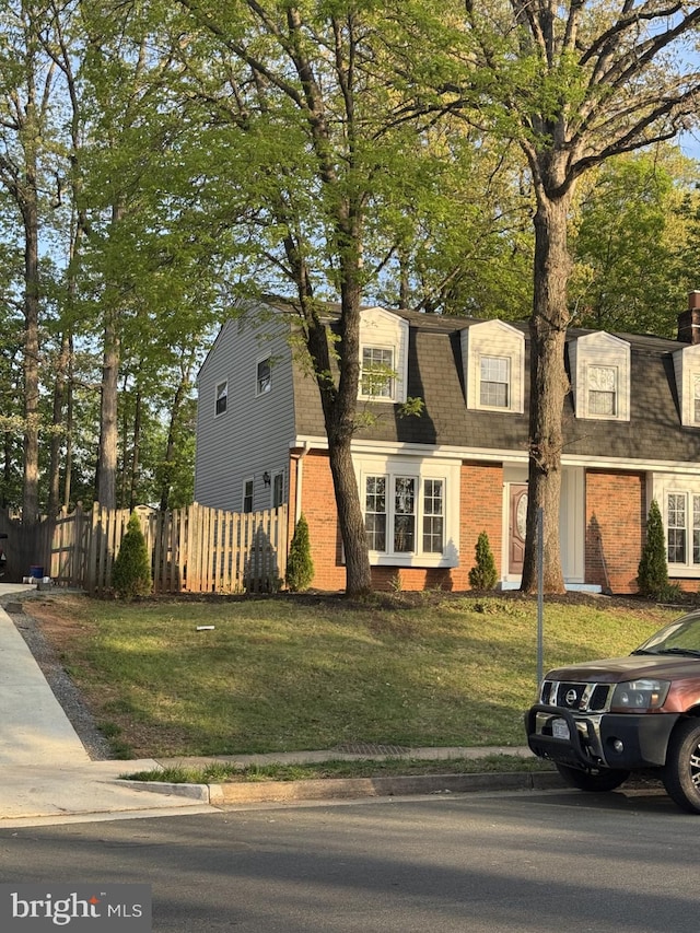 8549 Stonewall Rd, Manassas, VA 20110 - colonial inspired home featuring fence, a shingled roof, a front lawn, and brick siding