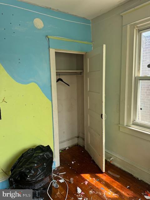 unfurnished bedroom featuring a closet and wood finished floors