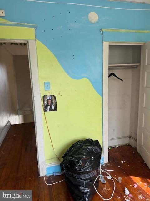 bedroom with wood-type flooring and a closet