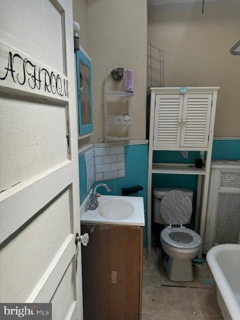 bathroom featuring toilet, tile patterned flooring, and vanity