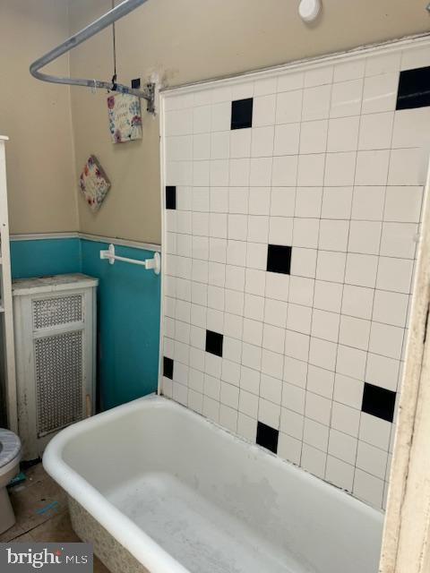 full bath with toilet and a bath