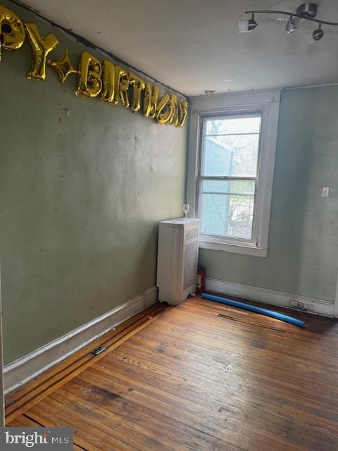 unfurnished room featuring hardwood / wood-style flooring