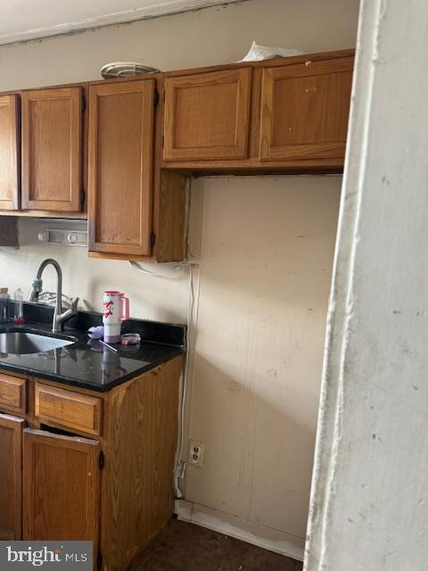 kitchen featuring a sink and brown cabinets