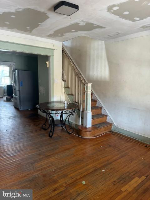 staircase with wood-type flooring