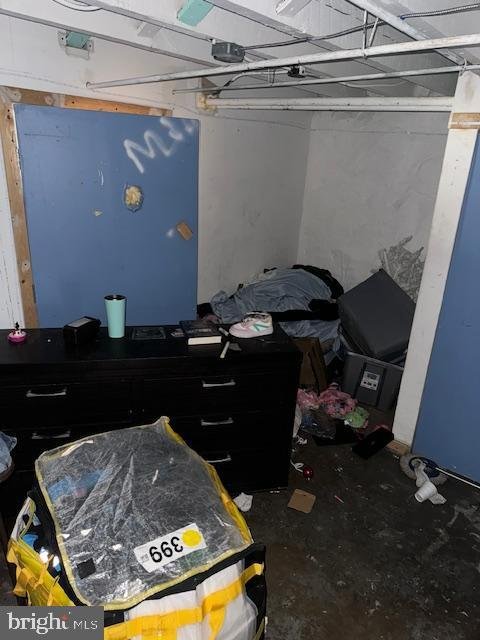 bedroom featuring unfinished concrete flooring