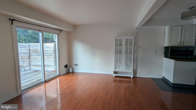 14743 Tamarack Pl, Woodbridge, VA 22191 - unfurnished living room with wood finished floors and baseboards