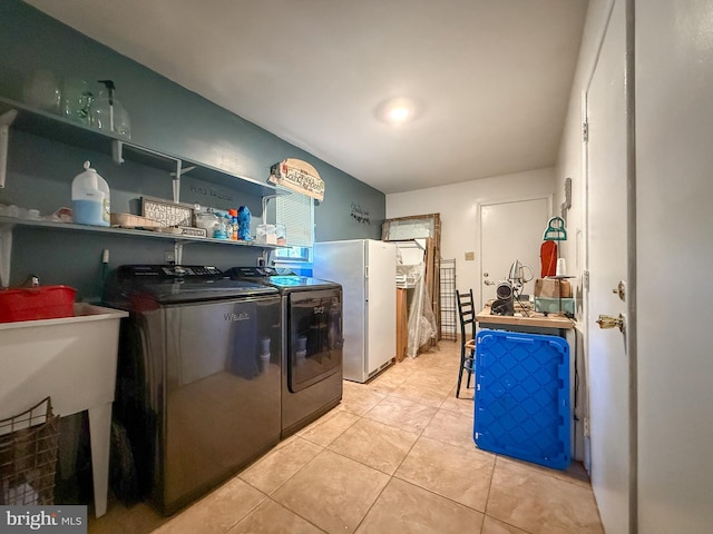 laundry room with laundry area, light tile patterned floors, and washing machine and dryer