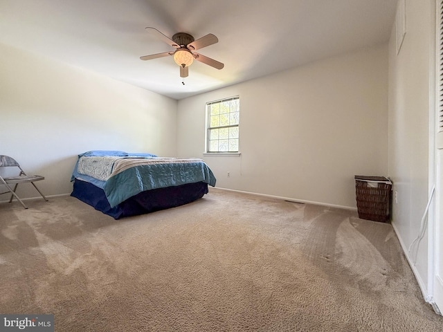 bedroom with baseboards, a ceiling fan, and carpet
