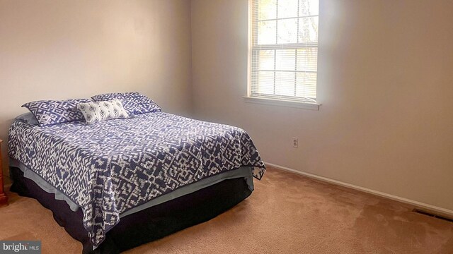 bedroom featuring baseboards, carpet, and visible vents