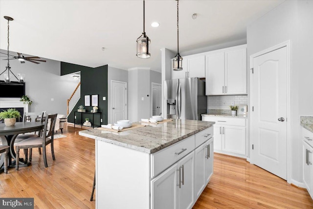 161 Stonecrest Cir, Keedysville, MD 21756 - kitchen with stainless steel refrigerator with ice dispenser, a center island, light wood-style floors, decorative light fixtures, and recessed lighting
