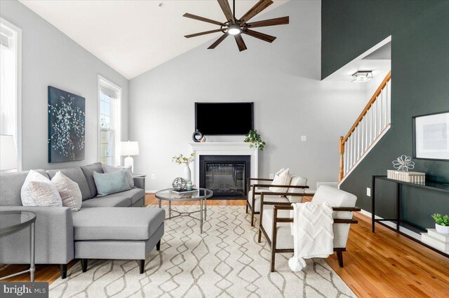 161 Stonecrest Cir, Keedysville, MD 21756 - living room with a ceiling fan, wood finished floors, high vaulted ceiling, stairway, and a glass covered fireplace