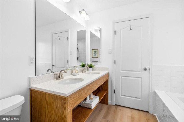 161 Stonecrest Cir, Keedysville, MD 21756 - bathroom featuring toilet, tiled tub, double vanity, and wood finished floors