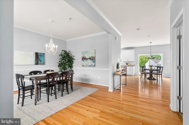 161 Stonecrest Cir, Keedysville, MD 21756 - dining area featuring a chandelier, light wood-style floors, crown molding, and baseboards