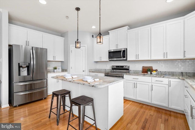 161 Stonecrest Cir, Keedysville, MD 21756 - kitchen featuring stainless steel appliances, white cabinetry, a center island, recessed lighting, and tasteful backsplash