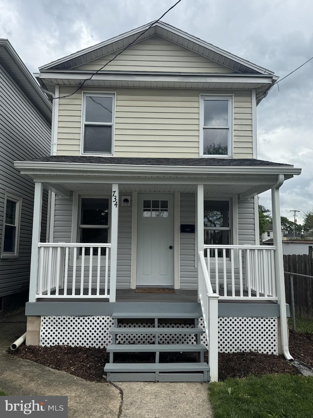 view of front facade featuring a porch and fence