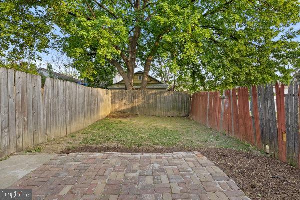 view of yard with a fenced backyard and a patio area
