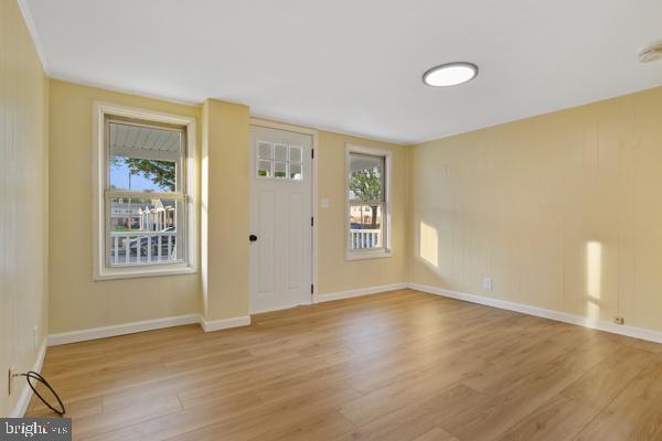 entryway with baseboards and light wood-style flooring