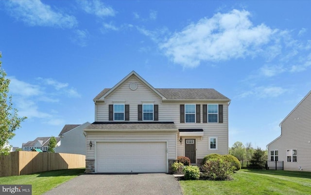traditional home featuring aphalt driveway, a garage, fence, a front lawn, and stone siding