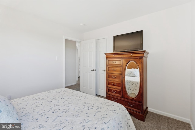 bedroom with baseboards and dark carpet