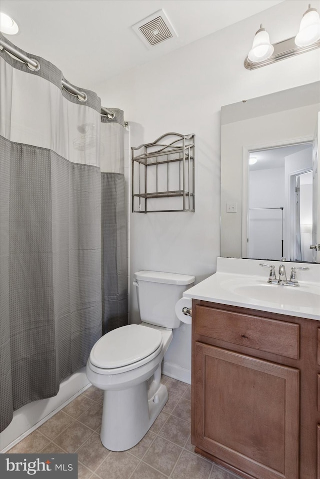 bathroom with vanity, toilet, tile patterned floors, and visible vents